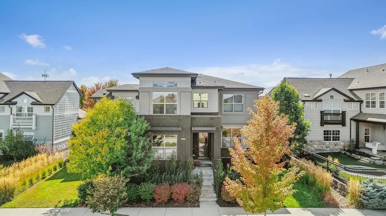 Modern two-story exterior with fall landscaping
