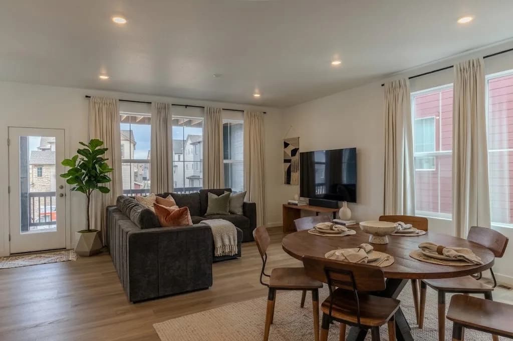 Living and dining area with city-view windows