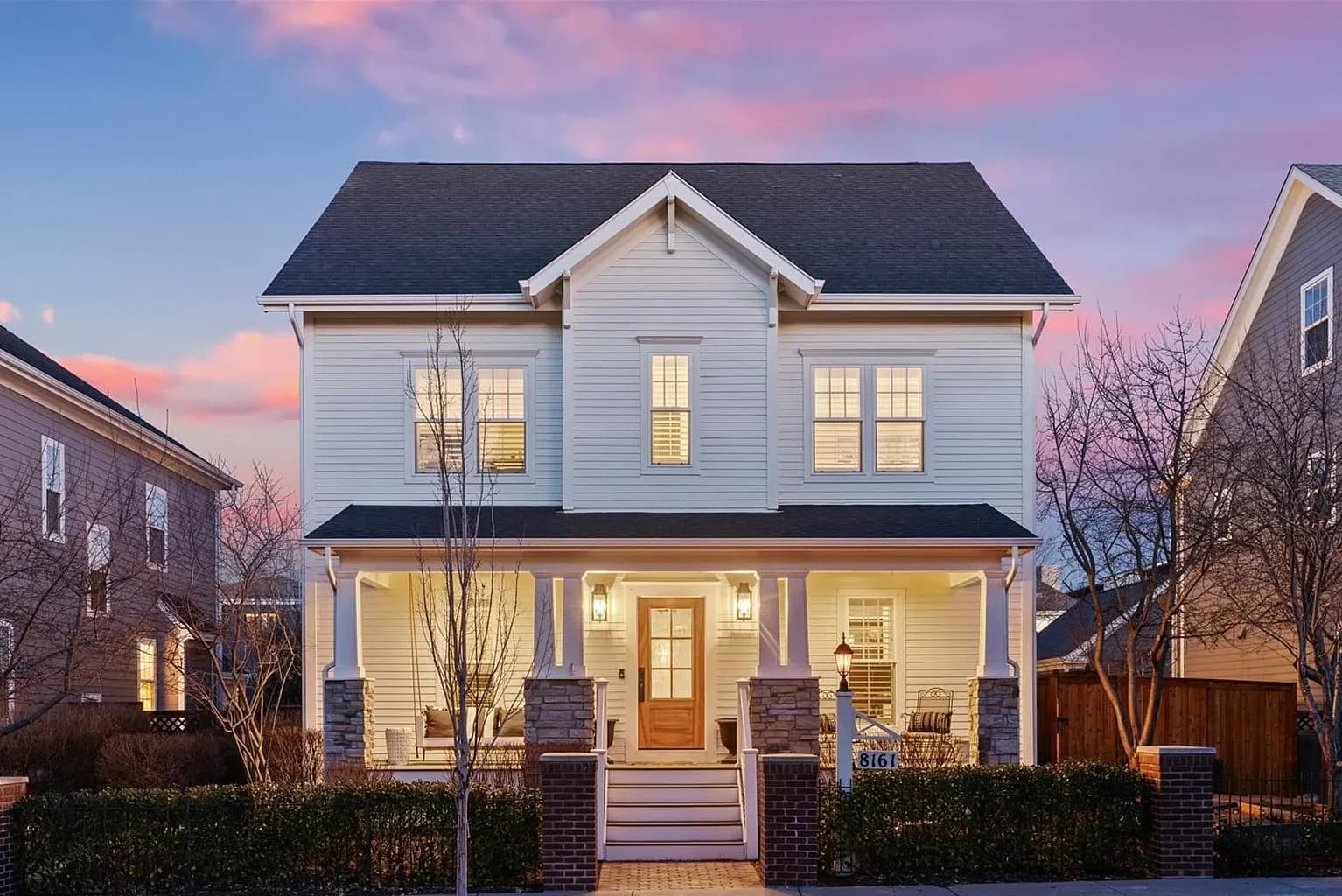 Twilight exterior — white colonial at dusk
